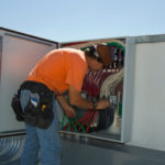 Engineer Working on Electrical Box at Solar Power Plant